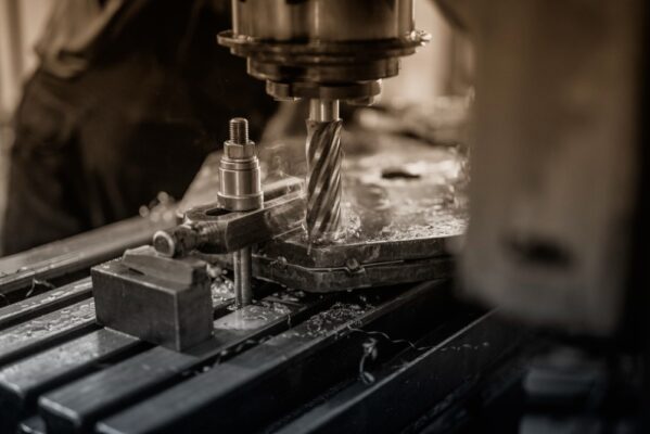Machine drilling into a piece of metal